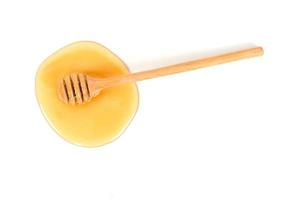 Honey with honey dipper on white background photo