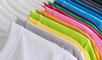 Colorful t-shirts hanging on a rack photo