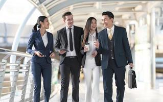 Business people walking and talk to each other in front of modern office photo