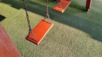Swing playground in the morning sunlight in spring video