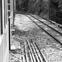 Shimla, Himachal Pradesh, India - May 14, 2022 - Toy train Kalka-Shimla route, moving on railway to the hill, Toy train from Kalka to Shimla in India among green natural forest photo