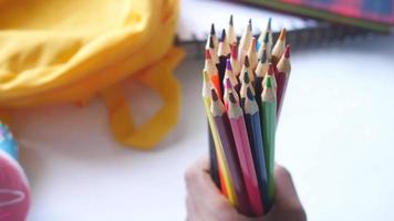 Child girl holding many color pencils video