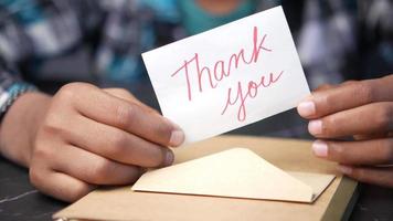 close up of man hand reading a thank you letter video