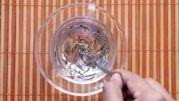 Dry tea leaves on in a tea cup top view video