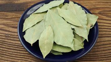 Dried bay leaves in ceramic bowl video