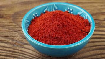 Red ground paprika spice in bowl video
