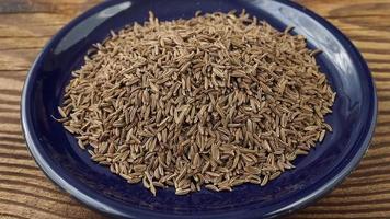 Aromatic roman cumin in a small bowl on the table video