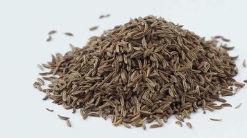 Pile of cumin seeds isolated on white background video