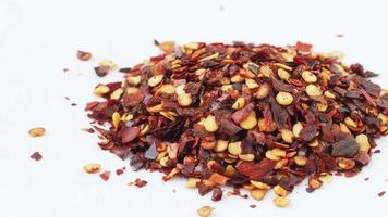 Dried chili flakes isolated on white background video