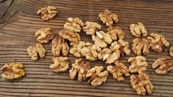 Raw walnut kernels on wooden table video
