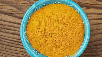 Curcuma powder in a small bowl on the table video