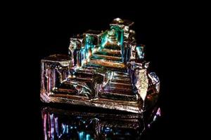 Macro mineral stone Bismuth on black background photo