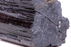 macro mineral stone sherle, schorl, black tourmaline on white background photo