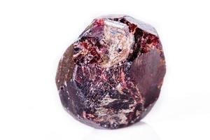 Macro of a mineral garnet stone on a white background photo