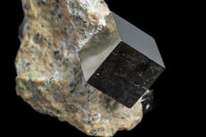 Macro Pyrite mineral stone on black background photo