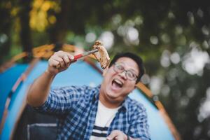 Portrait of Asian traveler man glasses pork steak frying photo