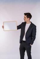 Portrait of happy businessman showing blank signboard on isolated white background photo