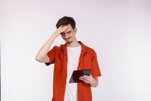 Portrait of stressed man using tablet standing isolated over white color background photo