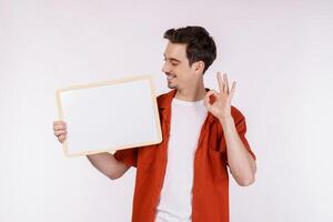 Portrait of happy man showing blank signboard on isolated white background photo