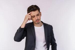 Portrait of thinking man surrounded by question mark on isolated background photo