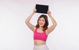 Portrait of excited young woman holding tablet mock up isolated over white background photo