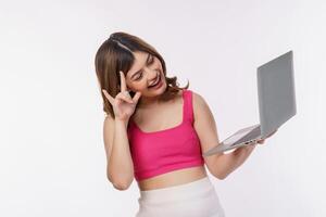 Portrait of young woman taking a photo with laptop computer isolated over white background