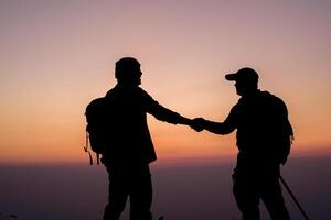 Silhouette of Teamwork helping hand trust help photo