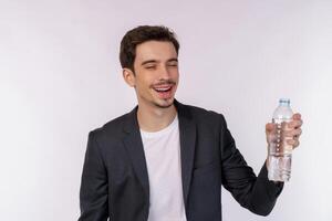 Portrait of Happy young man showing water in a bottle isolated over white background photo