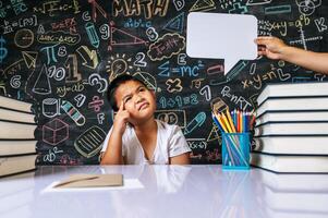 Child acting with speech bubble in the classroom photo