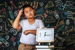 Child standing and acting in the classroom photo