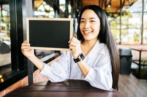 woman holding blackboard photo