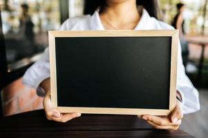 woman holding blackboard photo