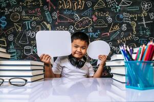 Child acting with speech bubble in the classroom photo