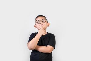 funny genius boy thinking in studio shot photo