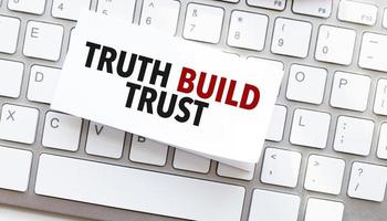 Text truth build trust written on paper sheet on a computer keyboard photo