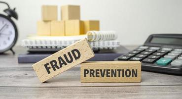 fraud prevention on the work table and alarm clock photo