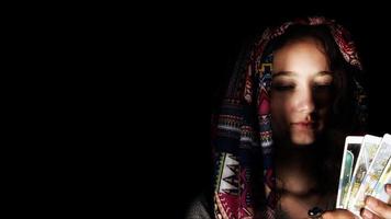 Young Girl in Headscarf Pose Holding Tarot Cards photo