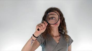 Young girl holding a magnifying glass photo