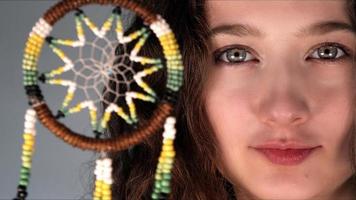 Young Girl is Holding a Dreamcatcher photo