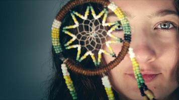 Young Girl is Holding a Dreamcatcher photo