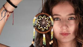 Young Girl is Holding a Dreamcatcher photo