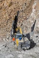 Drilling machine in open cast mining quarry photo