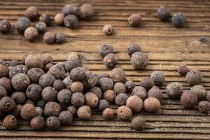 Allspice spice on wooden table photo