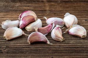 Garlic on dark rustic wooden background. photo