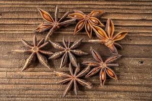 Dried star anise spice on vintage wooden board photo