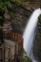 A built hiking trail leading to a waterfall photo