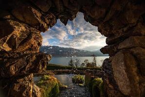 A stone window overlooking a lake photo