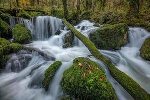 A waterfall whose stones are covered with moss photo