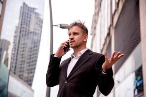 guy in a suit talking on the phone misunderstanding photo