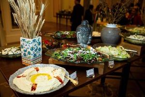 buffet table with various salads and snacks photo